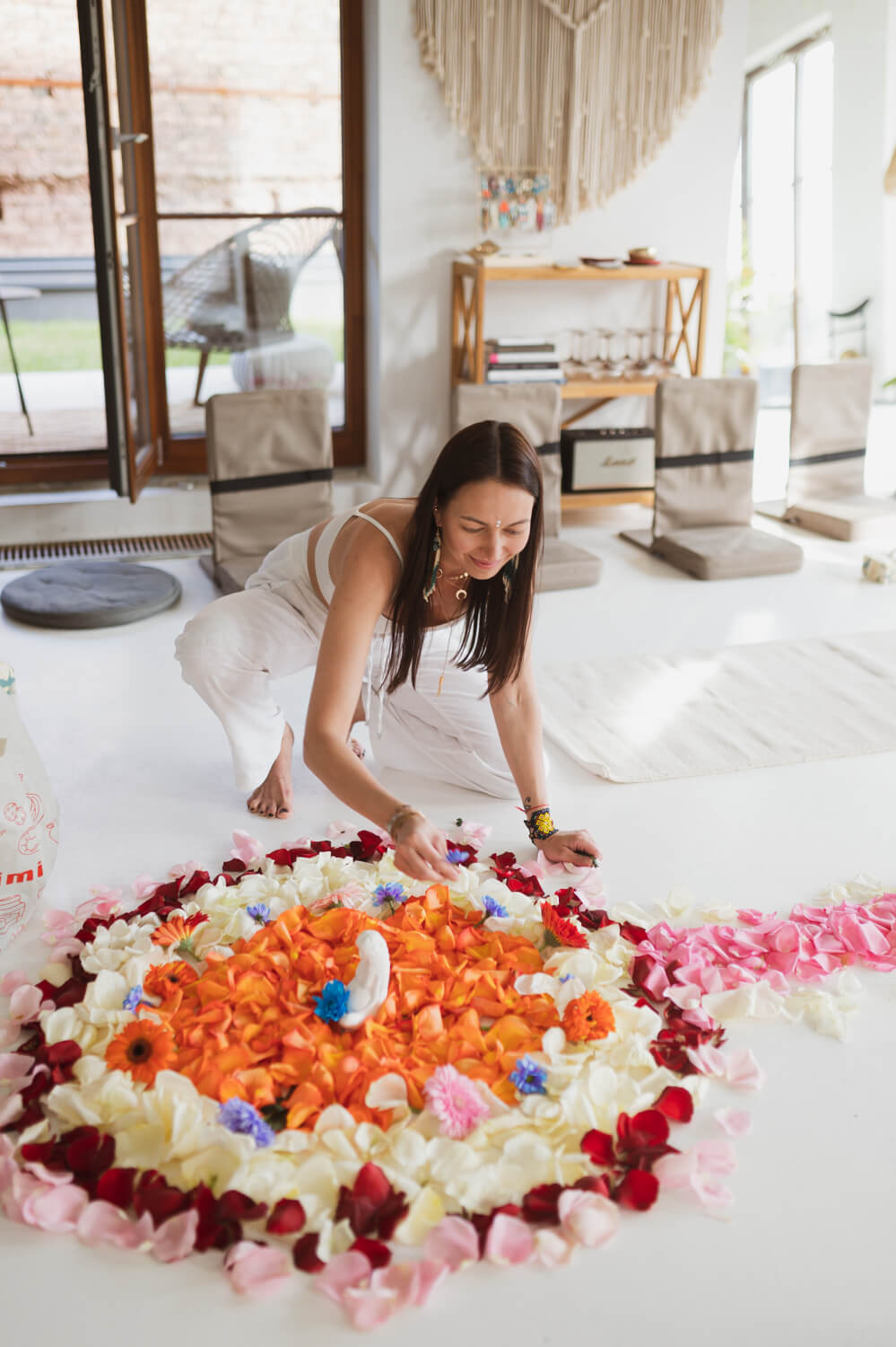 Woman arranging altar before a rapeh ceremony  with flowers